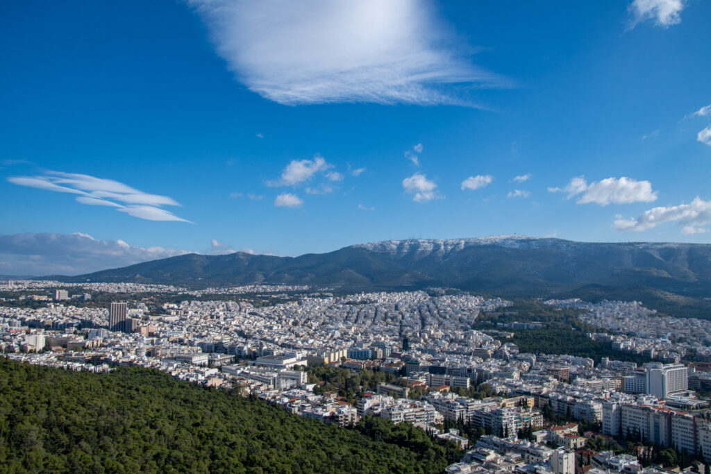 Uitzicht vanaf de Lycabettus over de daken van Athene met de bergen op de achtergrond
